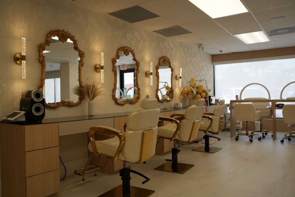 "Elegant reception area at To Beauty Hair Salon in Deerfield Beach featuring modern seating, chic decor and welcoming ambiance